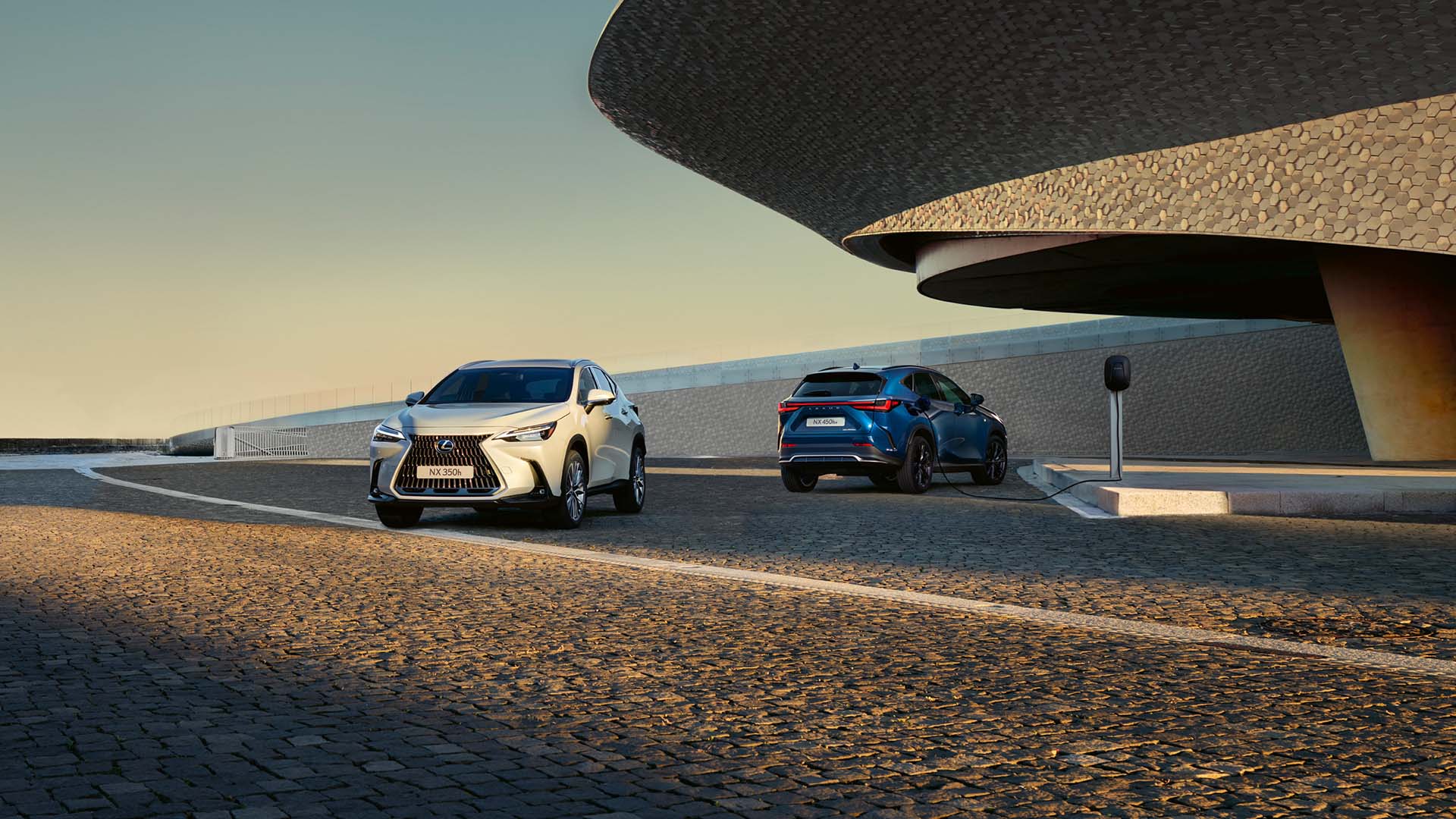 A person charging a Lexus NX using a charging box.