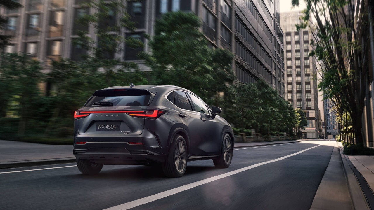 Lexus NX 450+ driving in a city location 