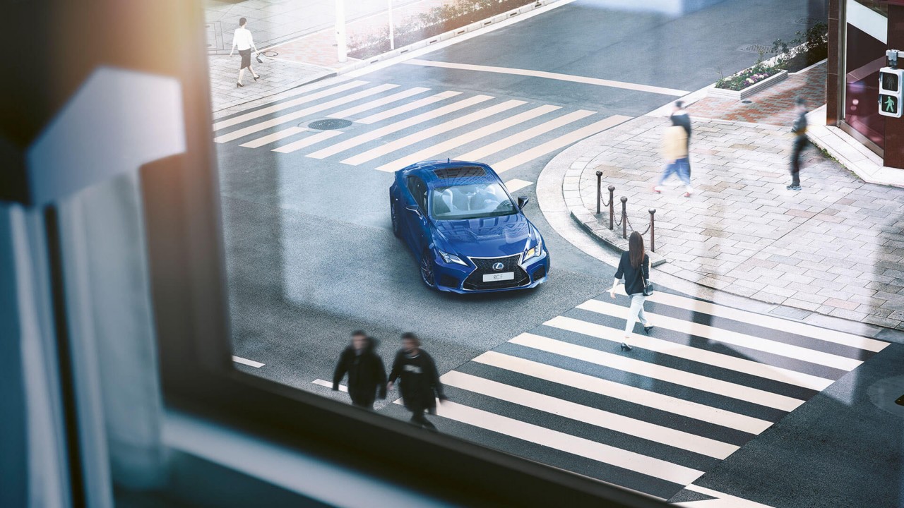 Lexus RC F waiting at a pedestrian crossing