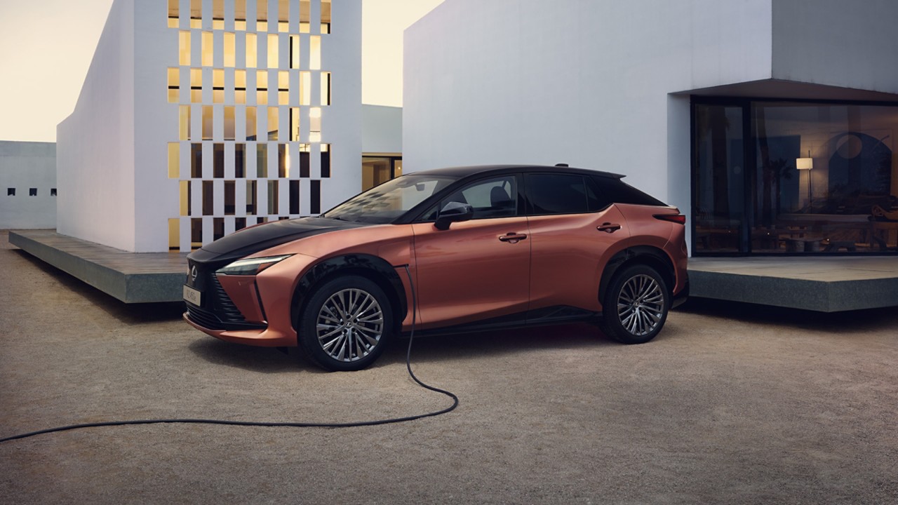A man plugging in a home socket into a Lexus UX 300e