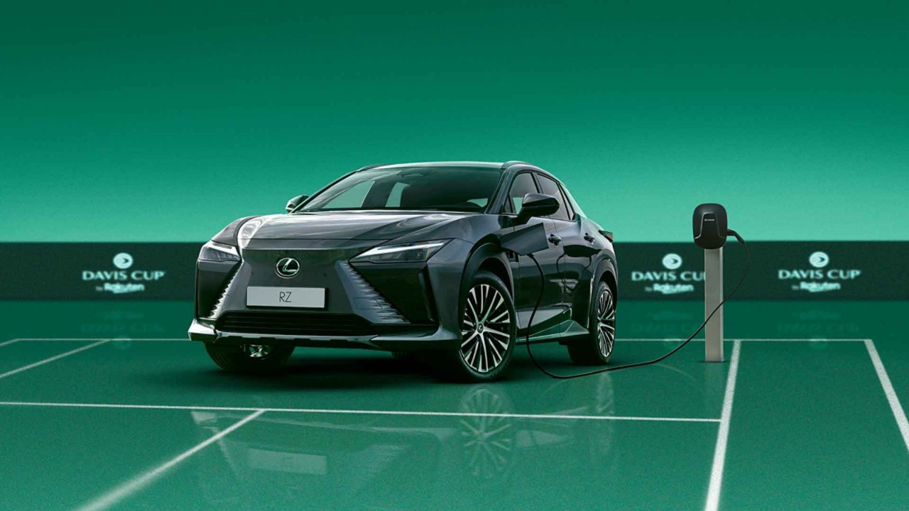 Lexus RZ plugged into a charging tower on a Davis Cup tennis court