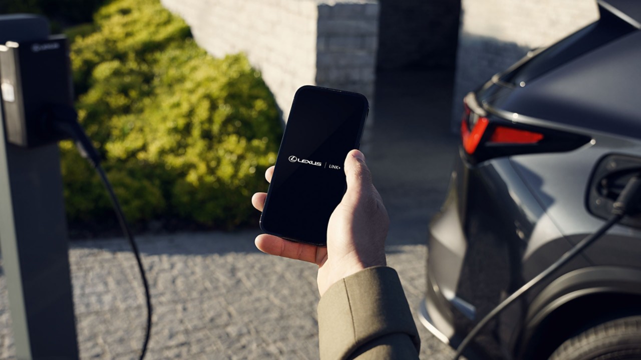 A person using a mobile phone to access the Lexus Link app