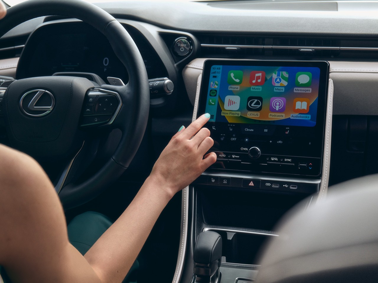 A person interacting with a Lexus multimedia touchscreen