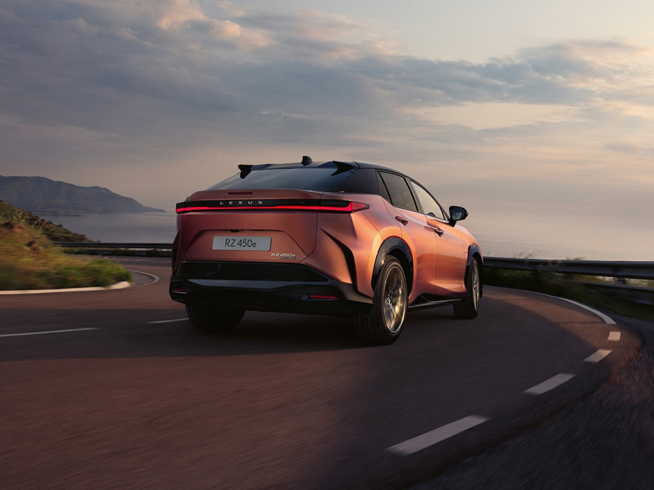 Lexus RZ driving along a coastline