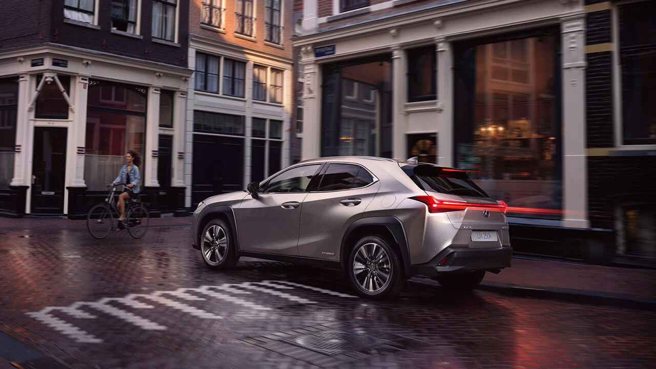 A Lexus UX on a city street, showcasing its sleek design and urban appeal.